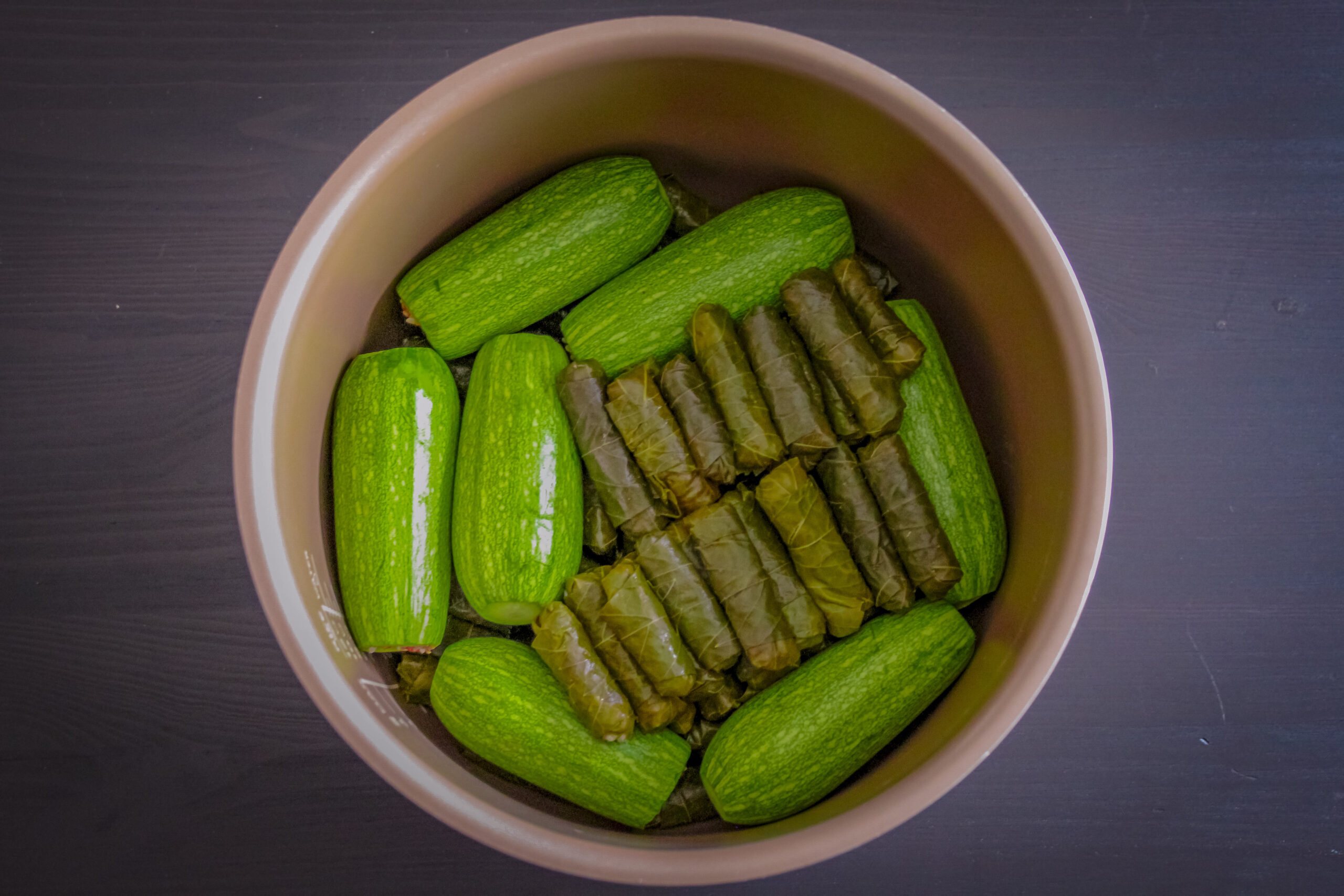 grape leaves and zucchinis in a pot